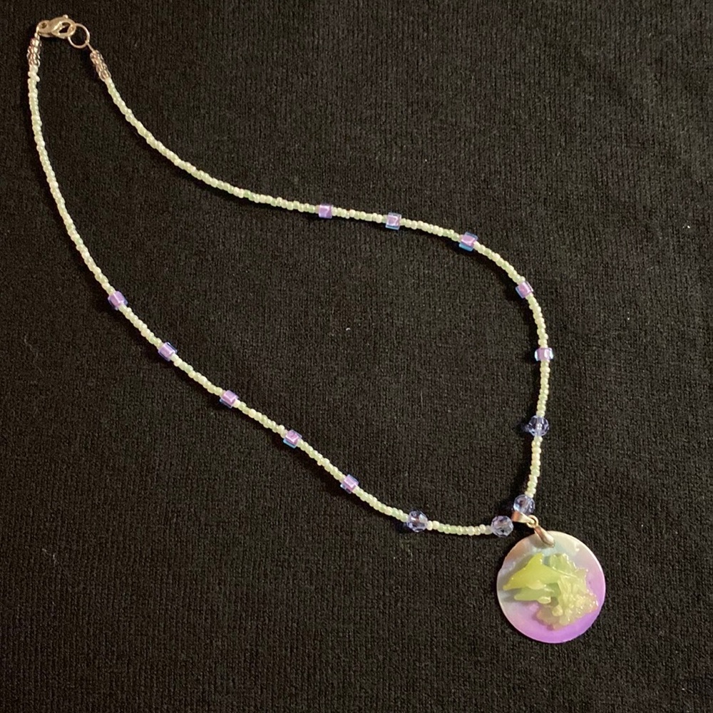 Dainty beaded necklace with 3 dimensional dolphins on the pendant